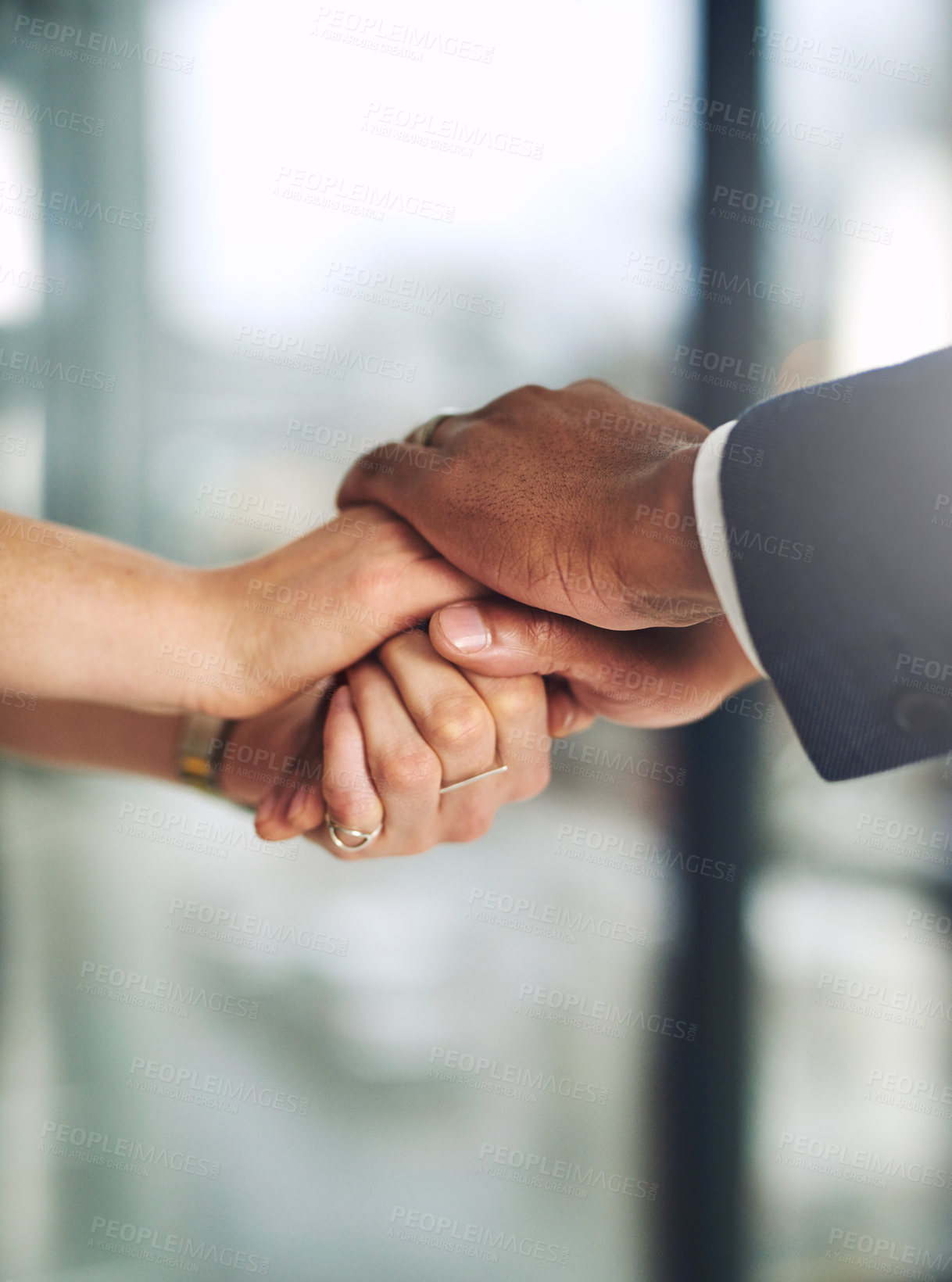 Buy stock photo Cropped shot of two colleagues holding hands