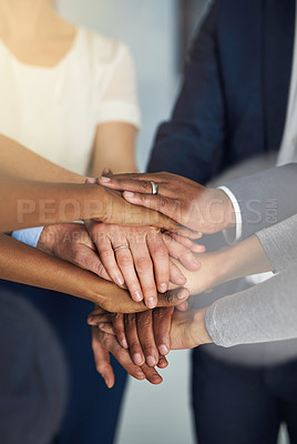 Buy stock photo Cropped shot of a team of colleagues joining their hands together in unity