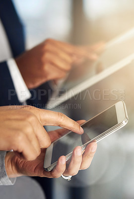 Buy stock photo Cropped shot of businesspeople using their tablets and phones at work