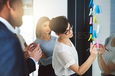 Buy stock photo Shot of a team of colleagues having a brainstorming session at work