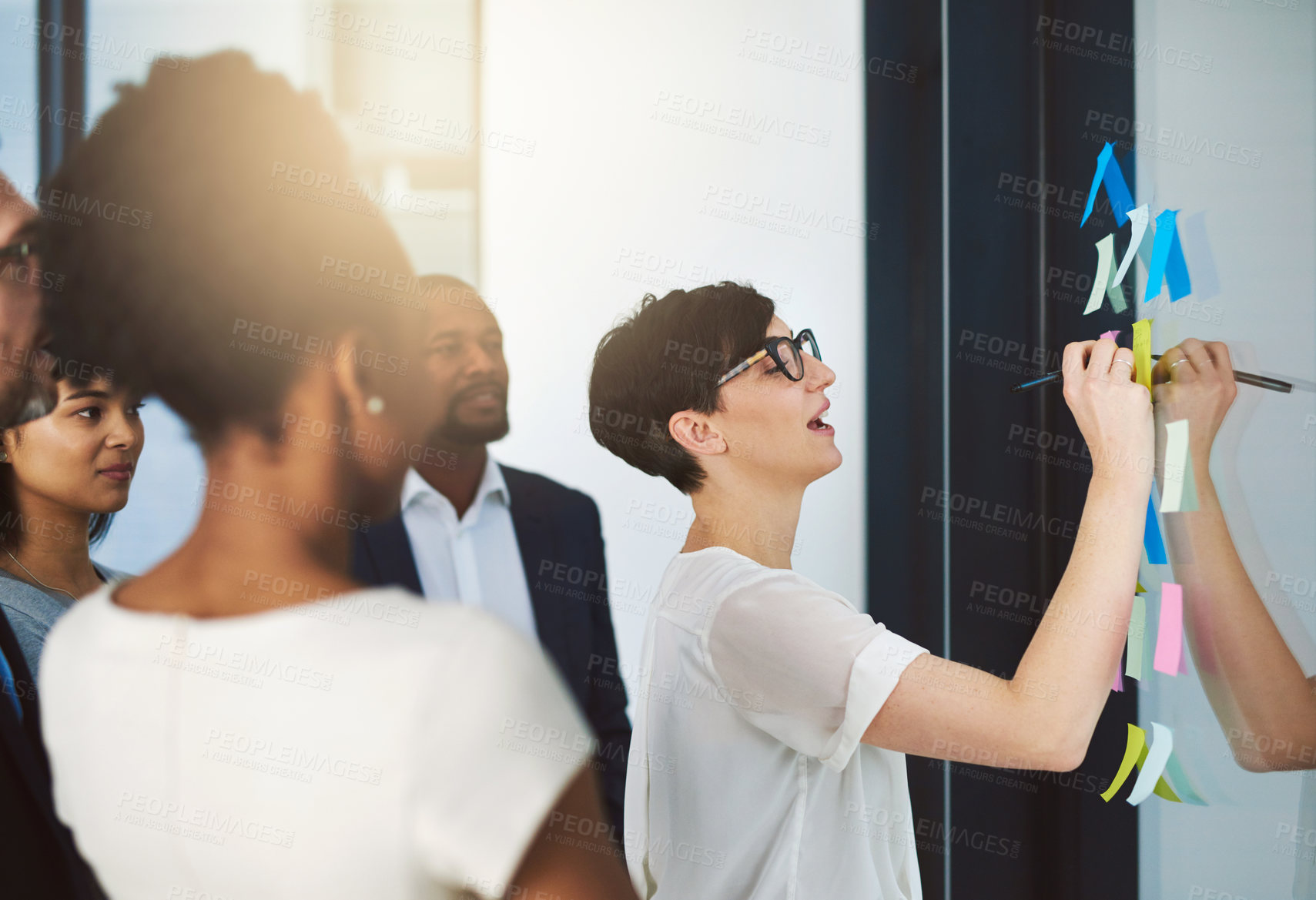 Buy stock photo Shot of a team of colleagues having a brainstorming session at work