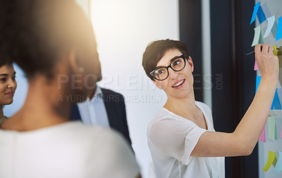 Buy stock photo Shot of a team of colleagues having a brainstorming session at work