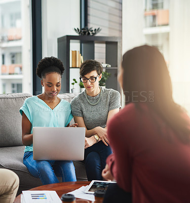 Buy stock photo Shot of colleagues working together on a laptop