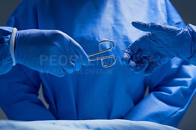 Buy stock photo Closeup shot of group of surgeons working on a patient in an operating room