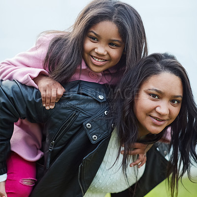 Buy stock photo Cropped portrait of a mother giving her young daughter a piggyback ride
