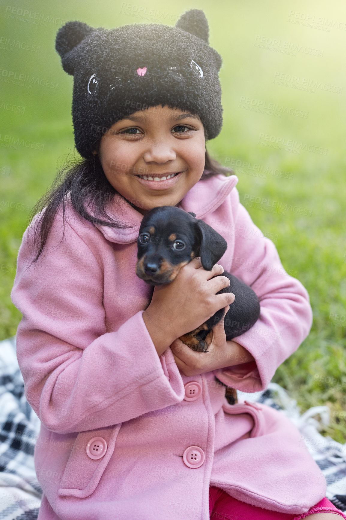 Buy stock photo Portrait, hug and happy child with dog outdoor for love, care and bonding together with pet animal at park. Smile, kid and embrace puppy at garden, friends and girl with dachshund on grass in Mexico