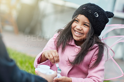 Buy stock photo Shot of a cute little girl having a tea party outside