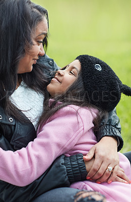 Buy stock photo Cropped shot of a mother and her young daughter bonding while sitting outside