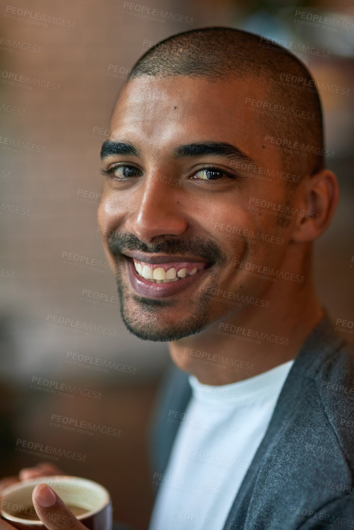 Buy stock photo Portrait of a young man enjoying a cup of coffee in a cafe