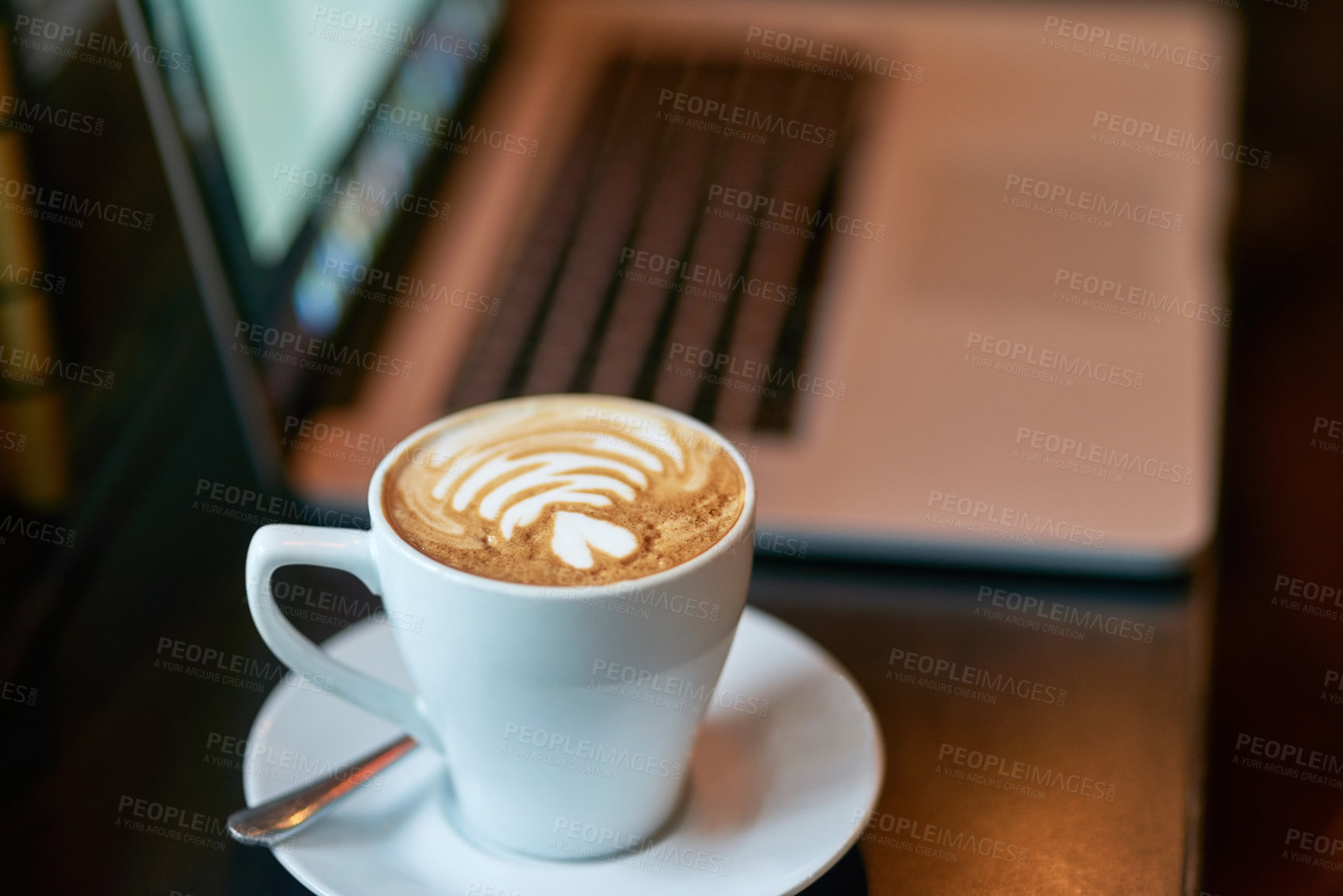 Buy stock photo Coffee, art and laptop in cafe on table, warm beverage and internet browsing with tech for online research or streaming. Restaurant, hospitality and customer experience, drink and latte for relax