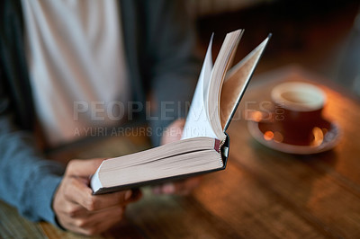 Buy stock photo Hands, person and book with coffee at cafe in table for reading novel or story for knowledge. Restaurant, literature and break in desk to chill, relax and lunch with notebook or journal with notes