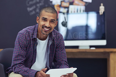 Buy stock photo Cropped portrait of a young designer working on his tablet in the office