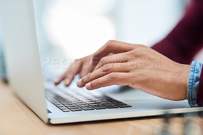 Buy stock photo Shot of an unidentifiable businessman using his laptop in his office