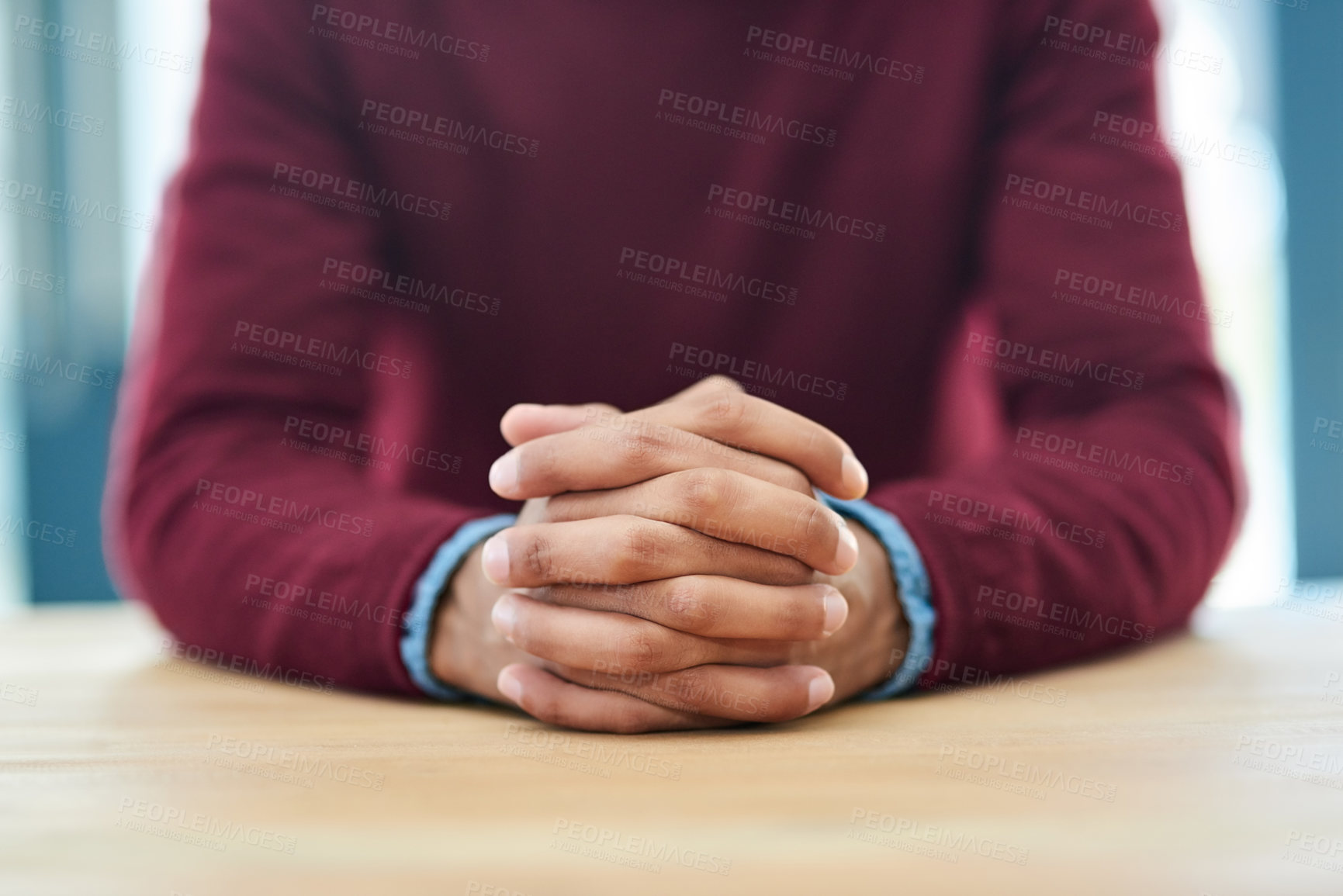 Buy stock photo Shot of an unidentifiable businessman sitting with his hands folded in the office