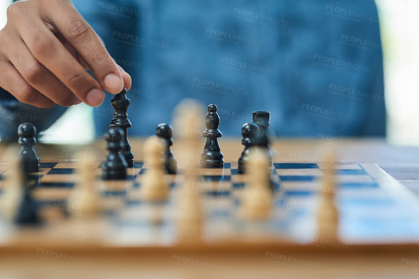 Buy stock photo Shot of an unidentifiable man moving a chess piece