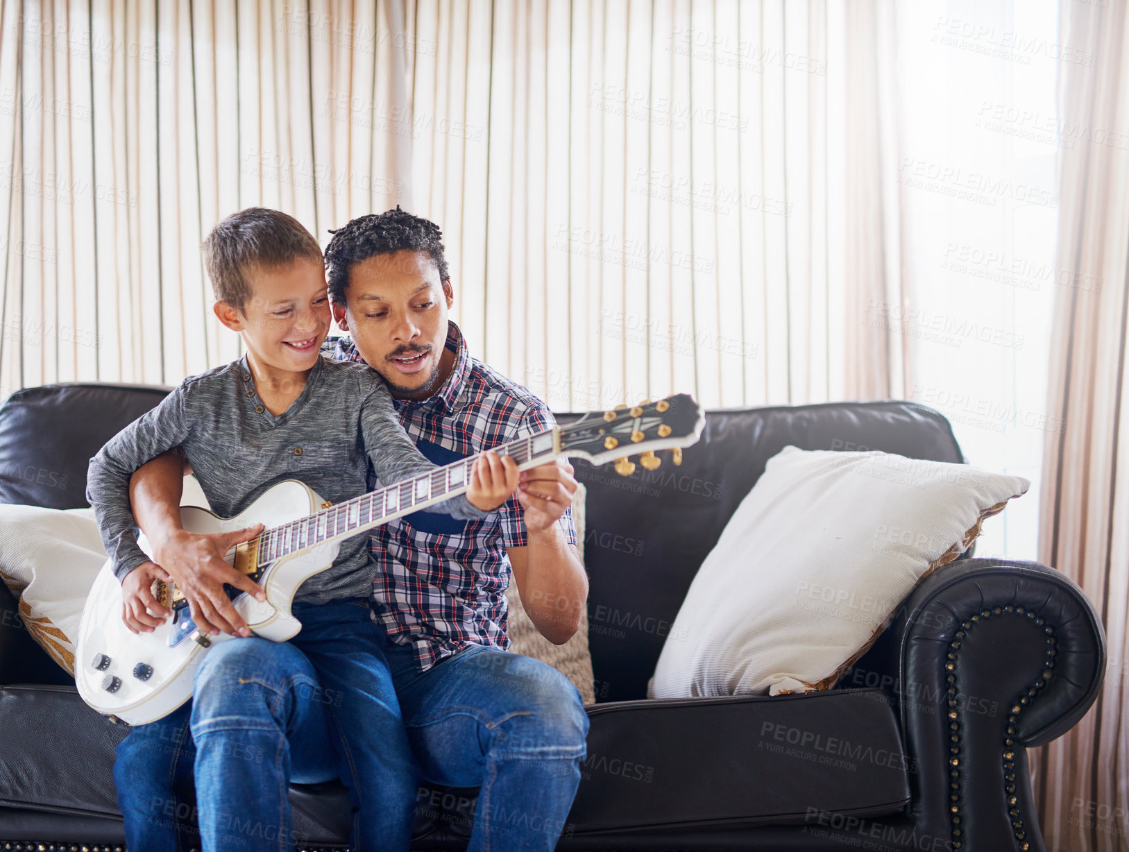 Buy stock photo Father, child and guitar together on sofa for learning music, practice skill and talent development. Acoustic instrument, dad and son playing on couch in home training for bonding and entertainment