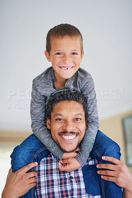 Buy stock photo Portrait of a father carrying his son on his shoulders at home