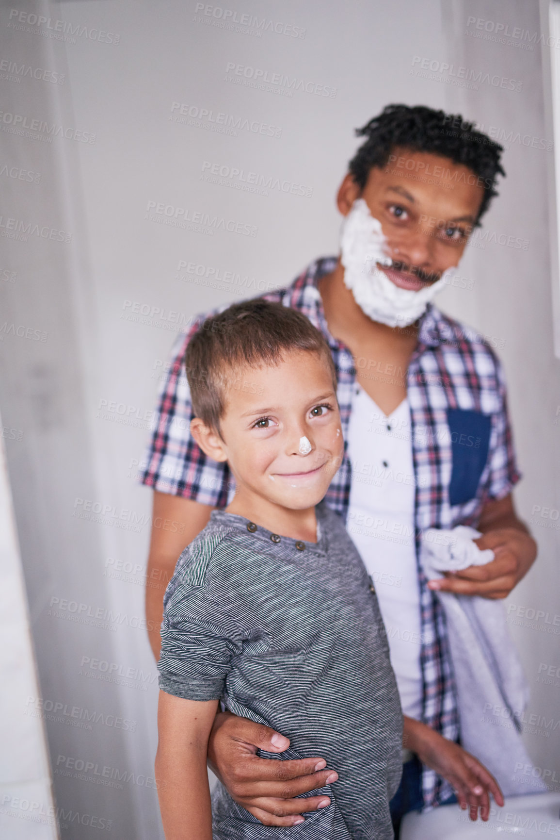Buy stock photo Portrait of a father and son shaving together in a bathroom
