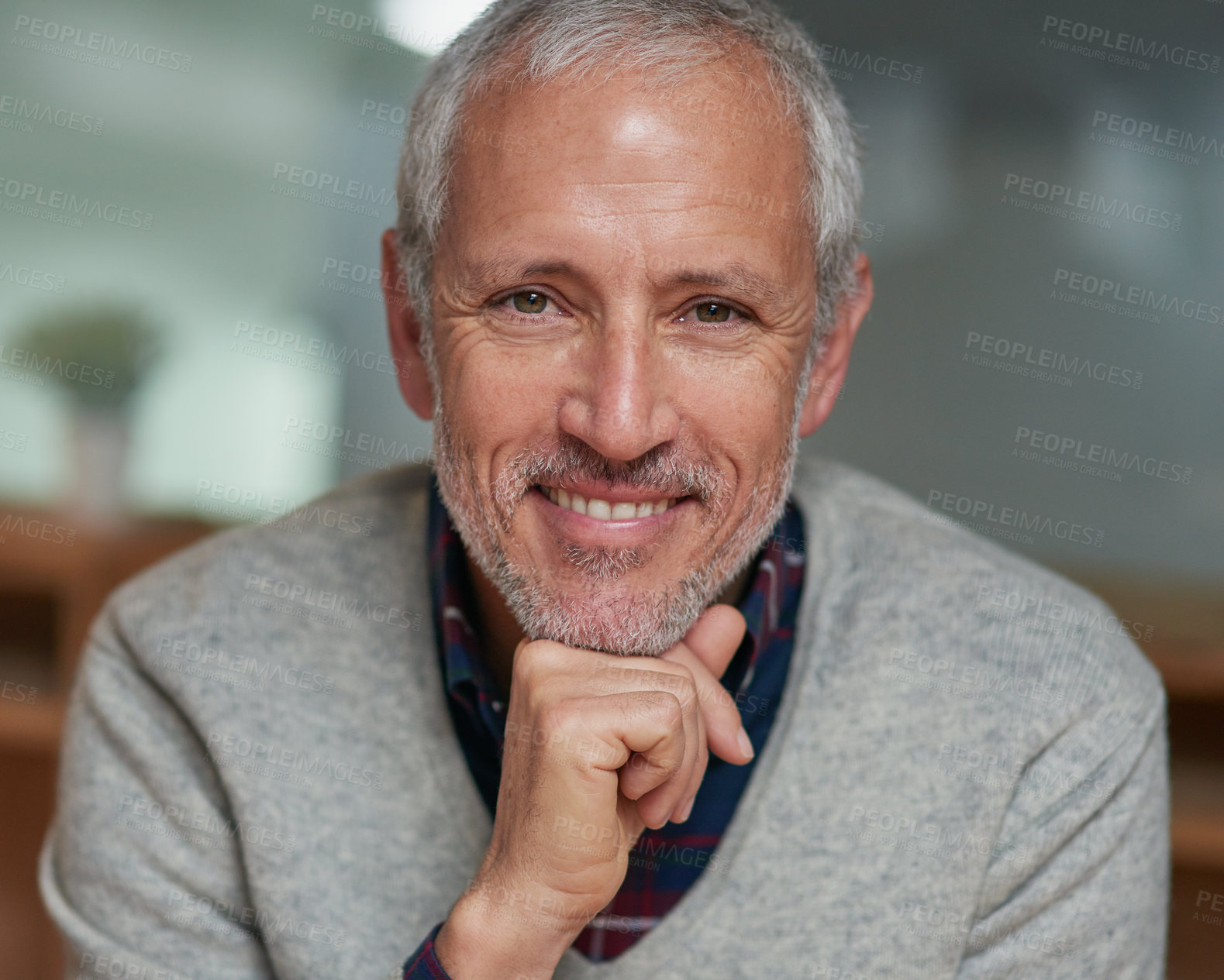 Buy stock photo Portrait of a smiling mature businessman sitting in an office