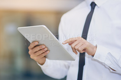 Buy stock photo Shot of an unrecognizable businessman using his digital tablet