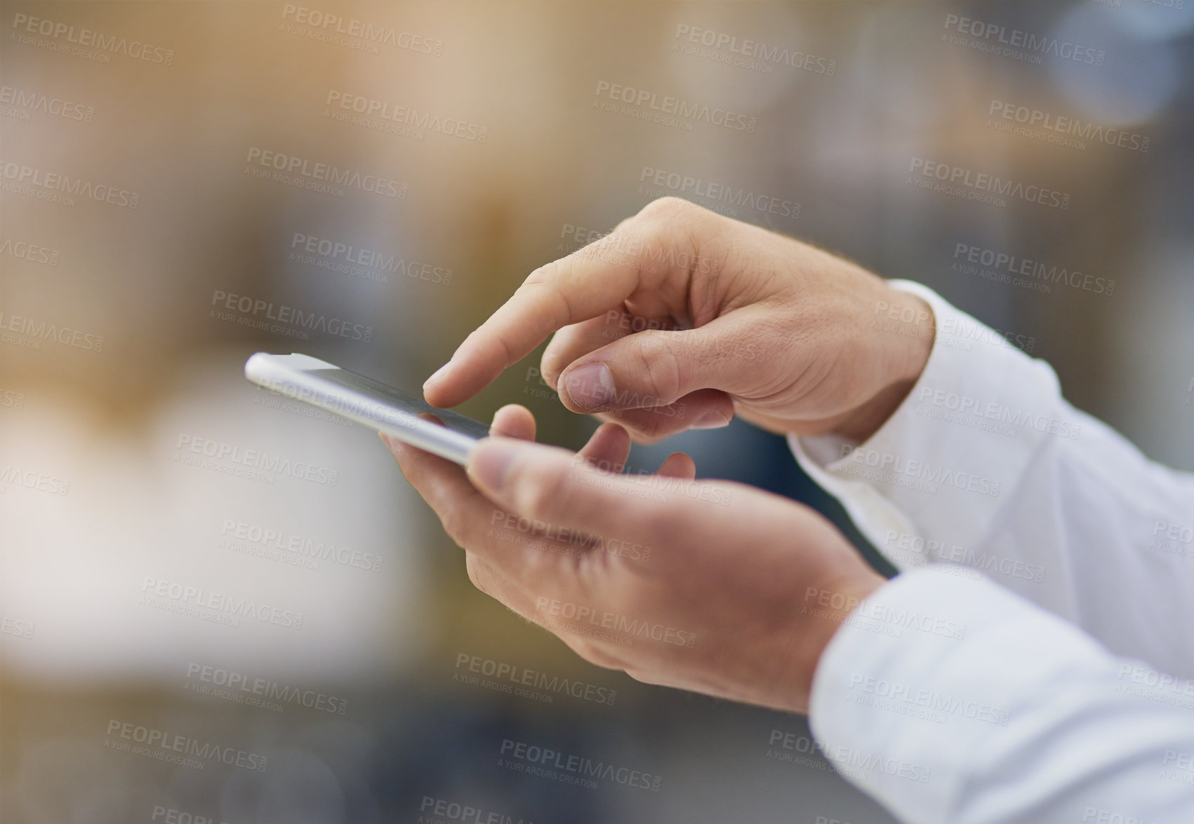 Buy stock photo Shot of an unrecognizable businessman using his cellphone