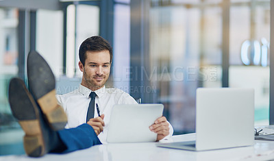 Buy stock photo Shot of a young businessman working in his office