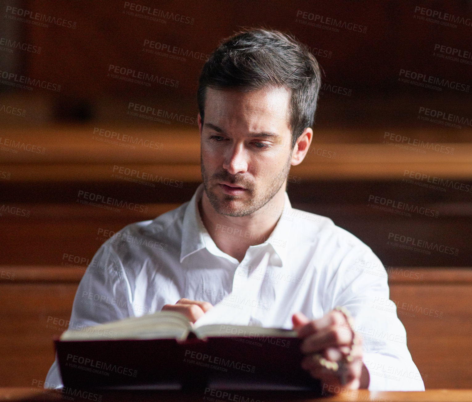 Buy stock photo Reading bible, man and thinking in church for prayer, faith or learning for spirituality. Christian male person, gospel or worship with holy book for healing, praise or religion for culture in chapel
