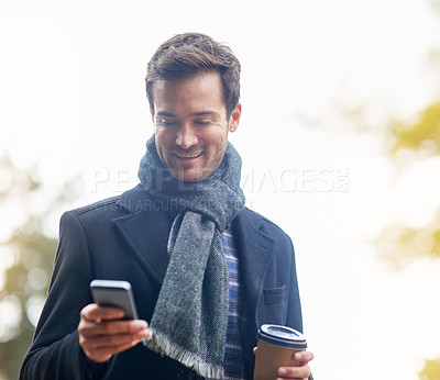 Buy stock photo Man, phone and outdoor with coffee, text and smile in communication, social media and technology in winter. Internet, tea and happy for message, email and walking or connection, chat and notification