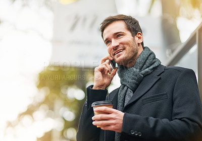 Buy stock photo Shot of a young man using his phone outside