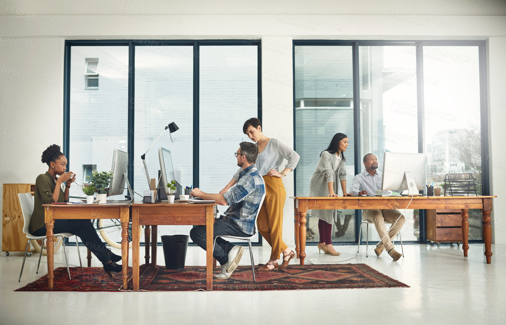 Buy stock photo Shot of a group of creatives working in a modern office