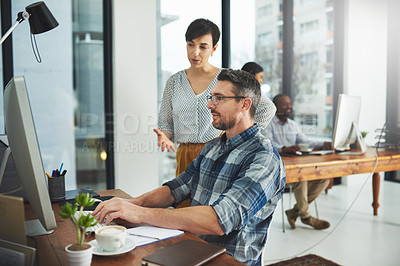 Buy stock photo Cropped of colleagues working together on a computer in a modern office