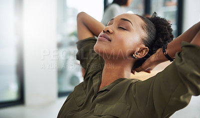 Buy stock photo Cropped shot of a young businesswoman taking a break at her desk
