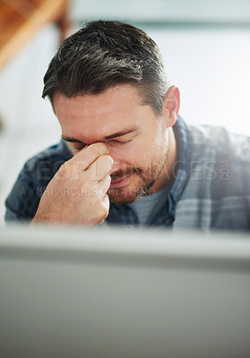 Buy stock photo Cropped shot of a mature businessman looking stressed out at his office desk