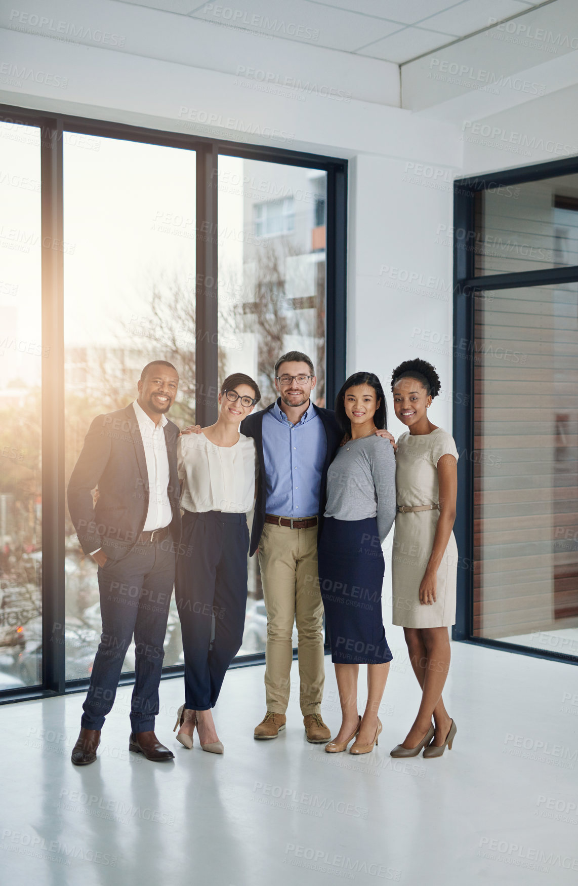 Buy stock photo Portrait of a diverse team of professionals standing together in the office