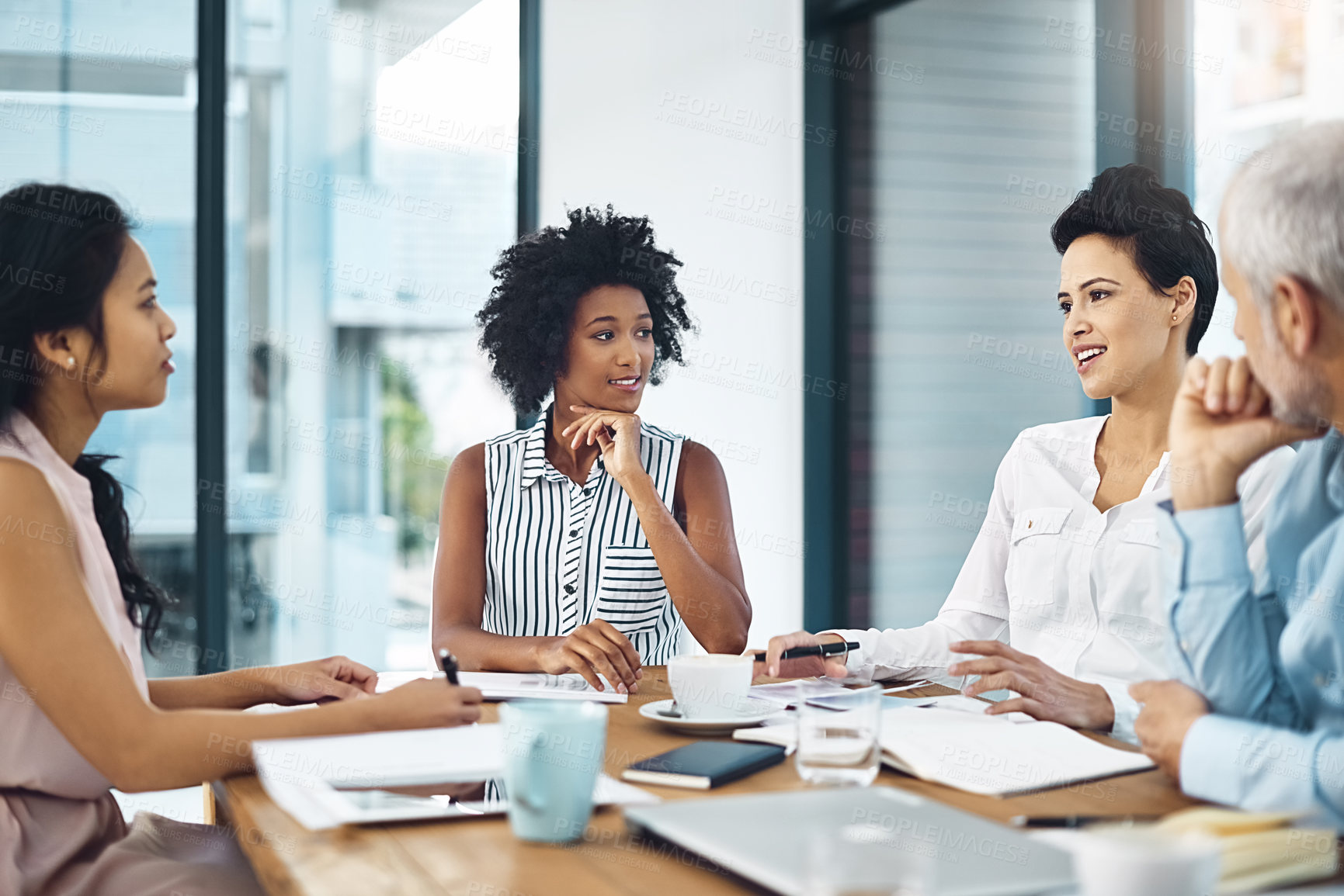 Buy stock photo Shot of a group of coworkers talking together in a meeting in an office