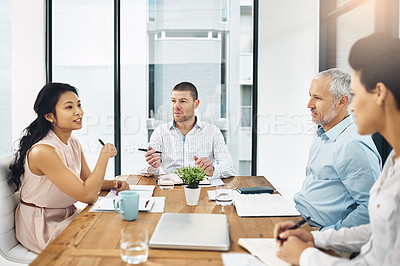 Buy stock photo Shot of a group of coworkers talking together in a meeting in an office