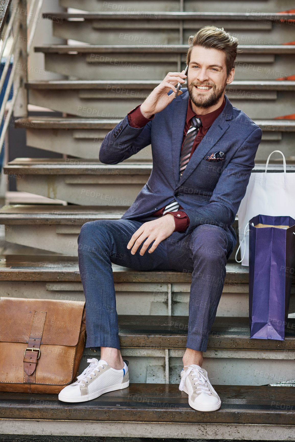 Buy stock photo Man, smartphone and call on stairs for fashion, communication and style in mall. Personal stylist, phone and confidence for shopping, clothes and trendy suit with conversation, bags and happiness