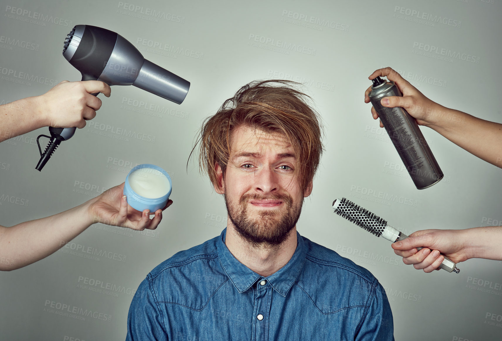 Buy stock photo Studio portrait of a young man getting a hair makeover against a gray background