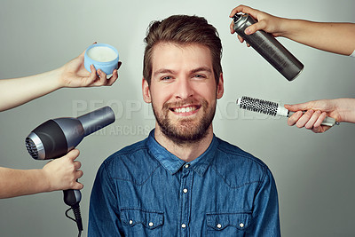 Buy stock photo Studio portrait of a young man getting a hair makeover against a gray background