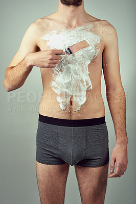 Buy stock photo Shaving body, man and grooming in studio for skin care, hair removal and daily routine on gray background. Male person, razor and foam on chest for hygiene, epilation and cleaning for wellness