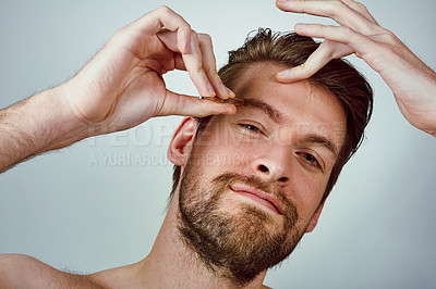 Buy stock photo Man, portrait and tweezer for grooming, eyebrows and pluck in hygiene, routine or treatment. Male person, white background and hair removal for wellness, skincare and mockup space or beauty in studio