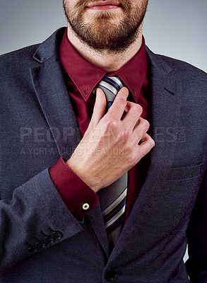 Buy stock photo Professional, businessman and hands on tie in studio as lawyer at firm with goal for company growth or future. Male person, formal and corporate for mission or project in agency on grey background
