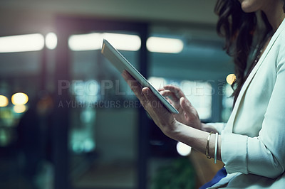 Buy stock photo Closeup shot of a businesswoman working late on a digital tablet in an office