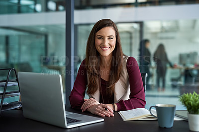 Buy stock photo Shot of a businesswoman sitting at her desk with her laptop