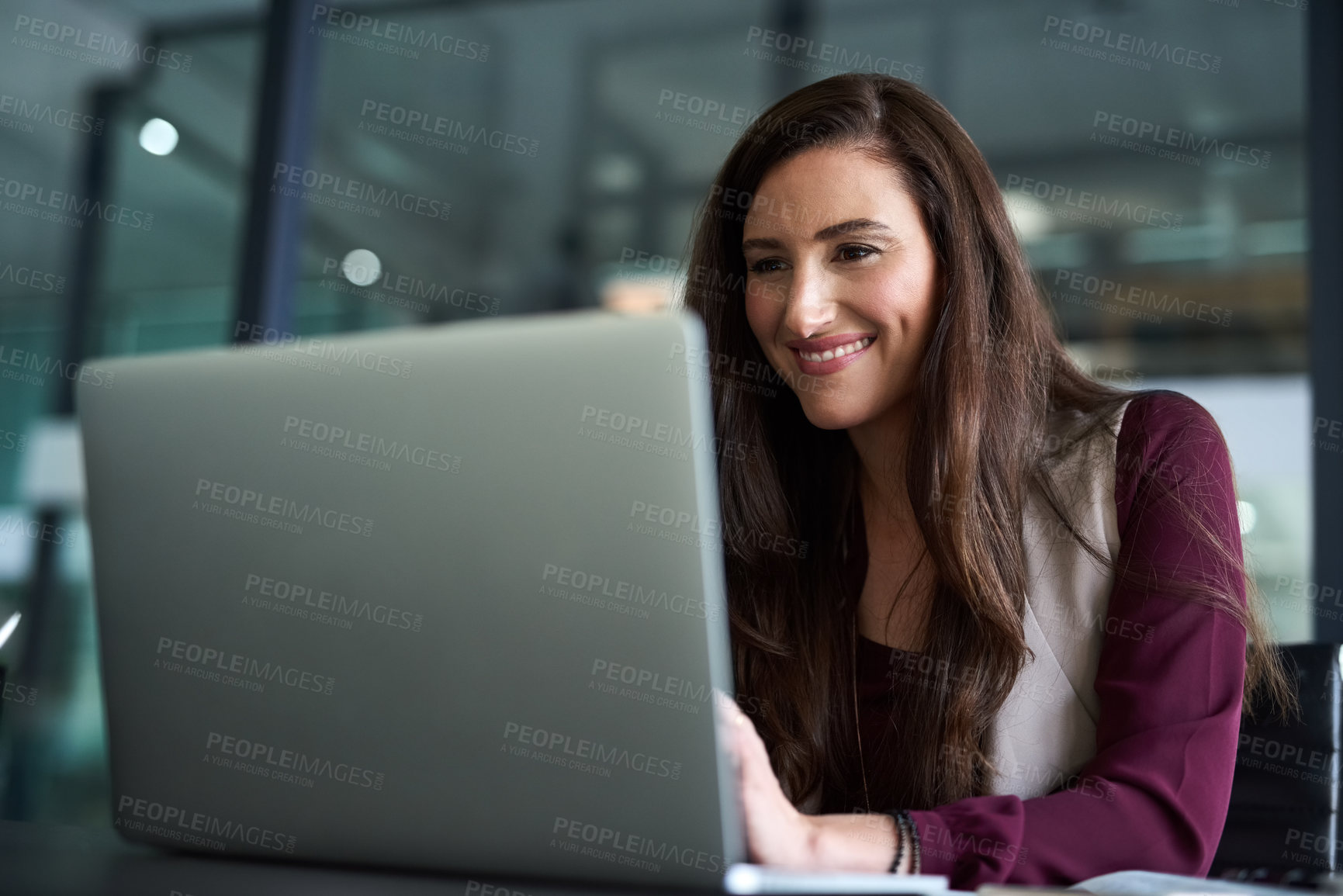Buy stock photo Shot of a businesswoman sitting at her desk with her laptop