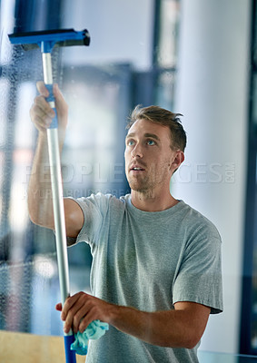 Buy stock photo Janitor, cleaning and man with window scraper for washing glass, housework and disinfect with shine. Male person, hygiene or sanitary services for health care, maintenance or hospitality professional