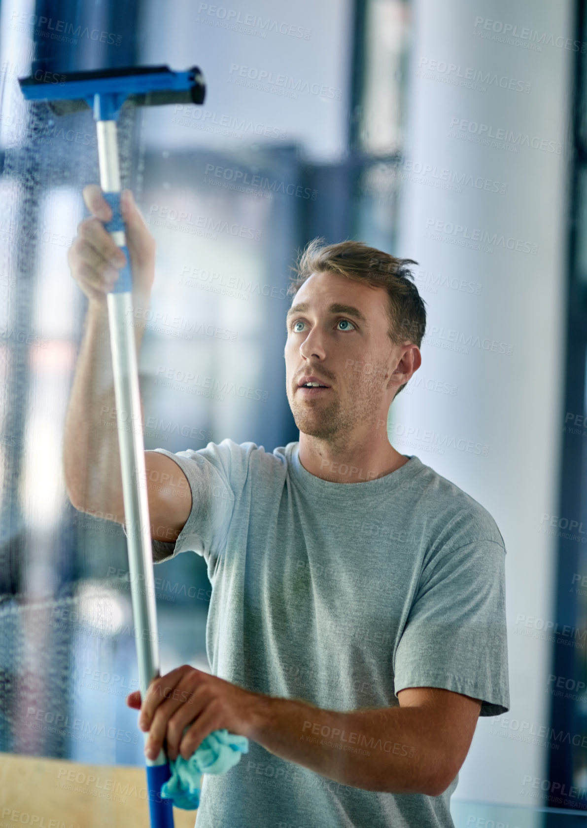 Buy stock photo Janitor, cleaning and man with window scraper for washing glass, housework and disinfect with shine. Male person, hygiene or sanitary services for health care, maintenance or hospitality professional
