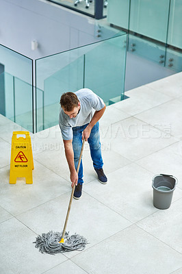 Buy stock photo Man, janitor and mopping office floor or cleaning hygiene with caution sign or water, soap or bacteria. Male person, disinfection and corporate building as washing service or dirty, wellness or job