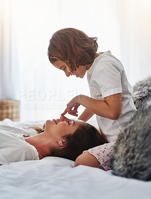Buy stock photo Cropped shot of a mother and daughter relaxing together at home in the morning