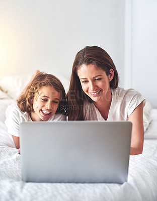 Buy stock photo Cropped shot of a mother and using a laptop together at home in the morning